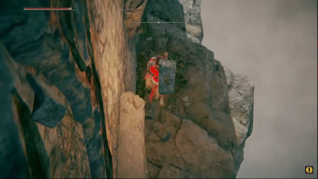 The player jumping down rocky ledges.