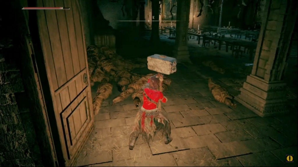 The player standing in a room with limbs hanging from the ceiling.
