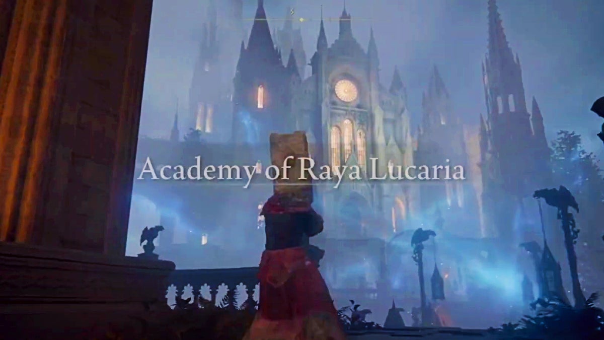 The player looking up at the entrance to Raya Lucaria at some gothic buildings among blue mist. The name of the academy appears over the screen as well.