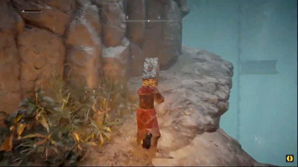 The player walking up a slope on the side of a cliff towards a huge lift in the distance.