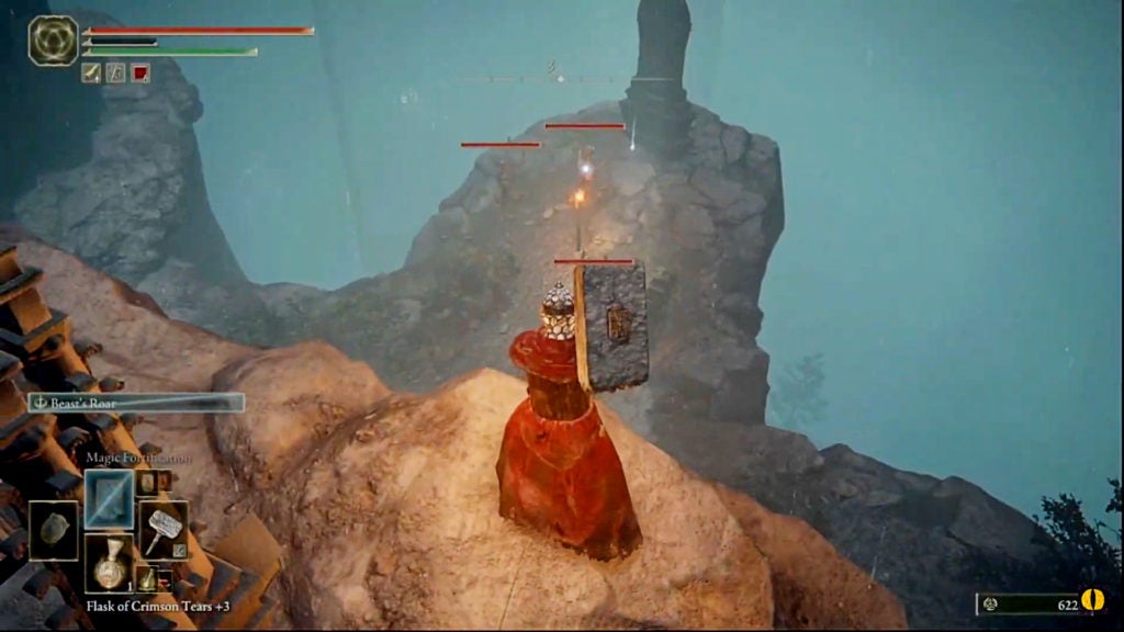 The player standing on a ledge and looking down at a few zombie enemies kneeling before a large tombstone.