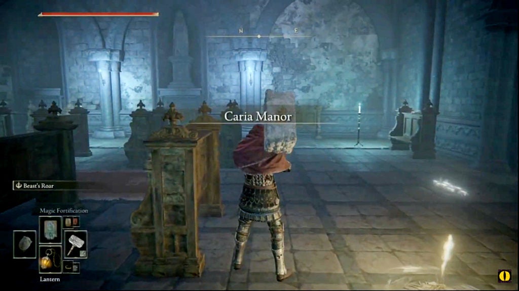 A player with a hammer standing inside the lower level floor of Caria Manor near a site of grace.