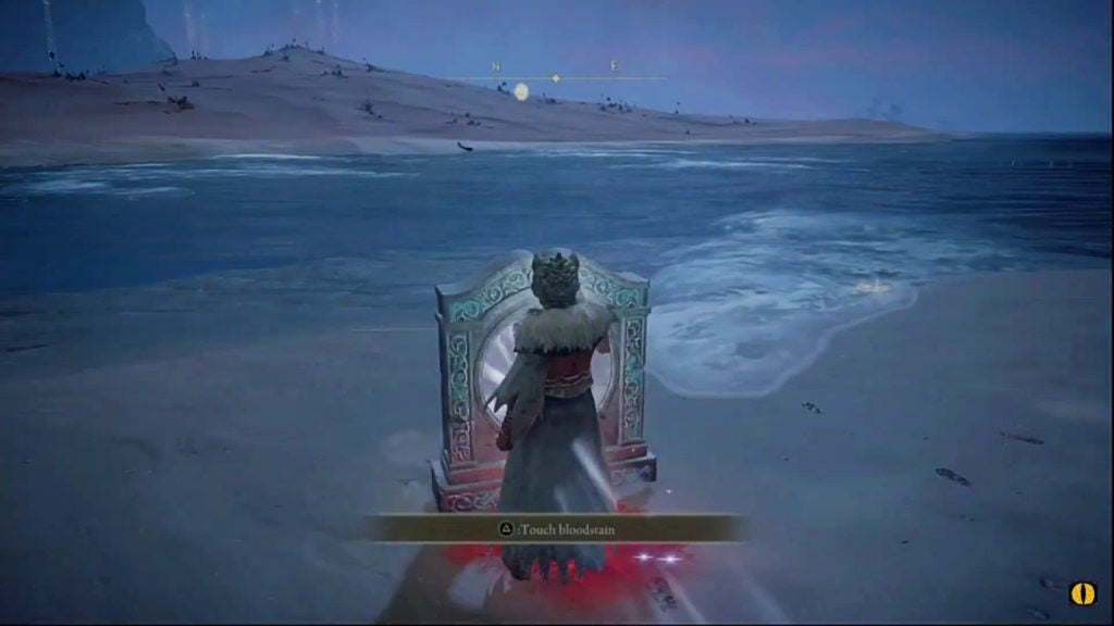 The player touching a teleporter facing the north while they stand on a beach at night.