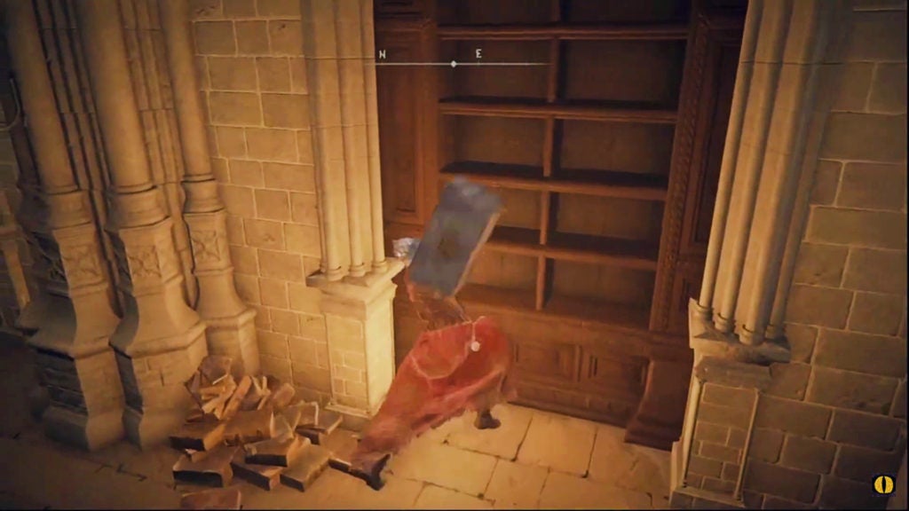 The player attacking a bookshelf with a hammer.