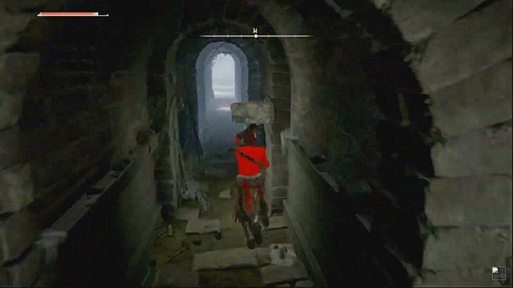 The player blocking with their hammer as they walk through a dark tunnel.