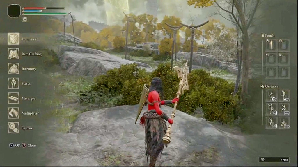 Side view of the player holding a golden halberd with two hands.