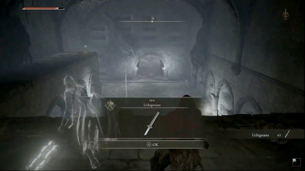 The player picking up an Uchigatana in a dark room.