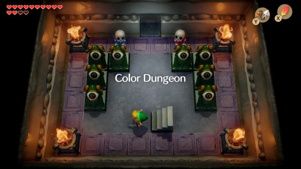 Link in the entrance of Color Dungeon and is being looked at by two colorful skeletons.