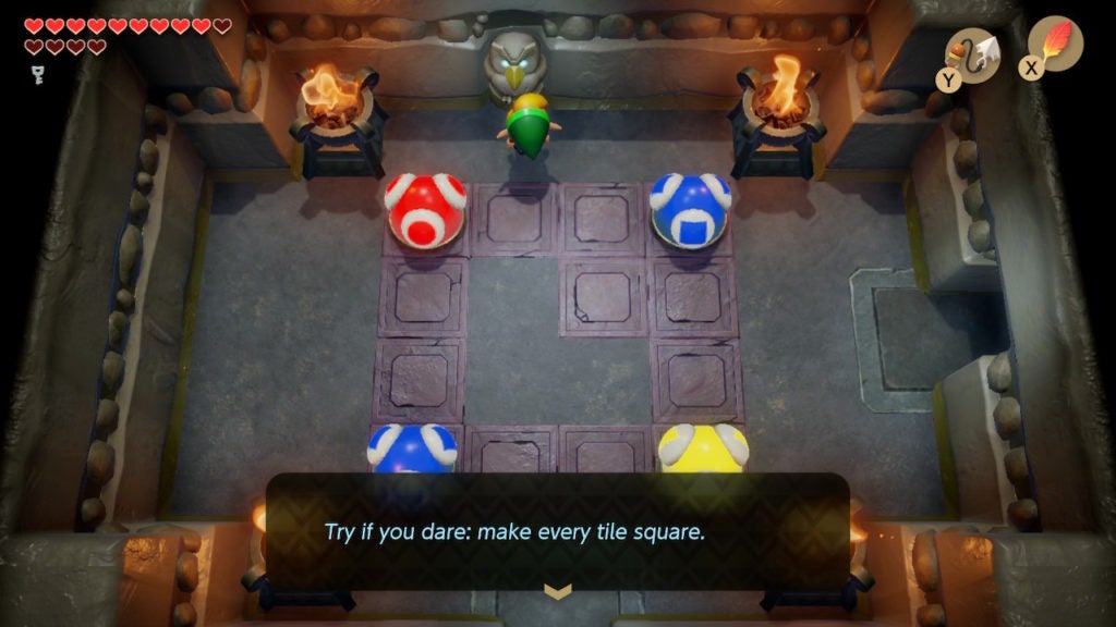 Link getting a hint from an Owl Statue in a room with red, blue. and yellow color bulbs.
