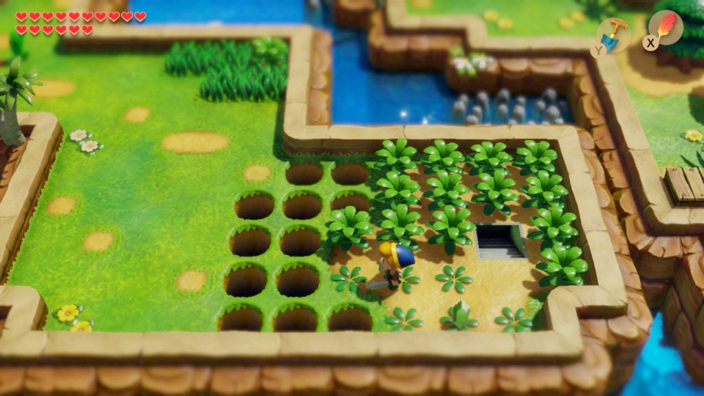 Link standing near a staircase surrounded by shrubs and holes.