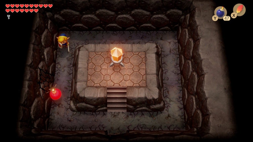 Link, in a room with an orange Switch crystal, has planted a bomb by a cracked wall on the west side of the room.