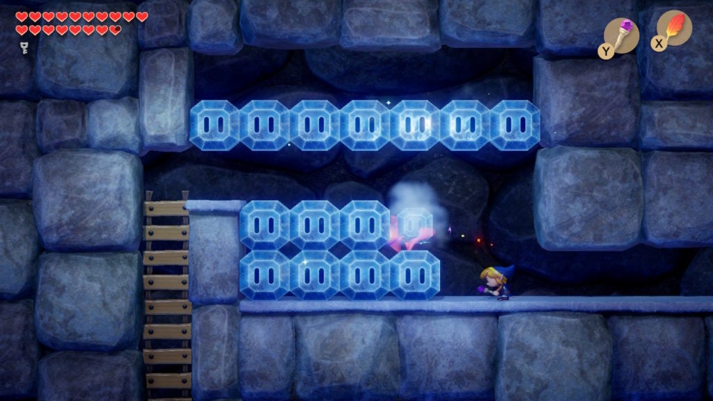 Link jumping and shooting a purple fireball at a higher row of ice blocks with the Magic Rod.