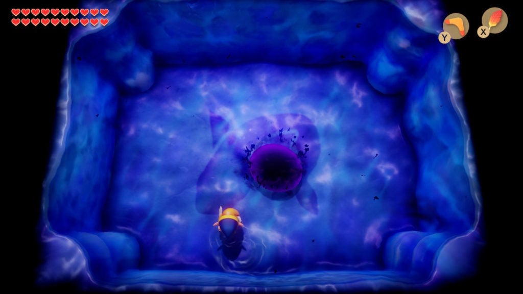 Link fighting dark blob in a blue room.