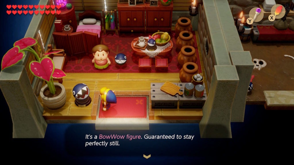 Link placing the BowWow Figure on the stand in Madame MeowMeow's house.