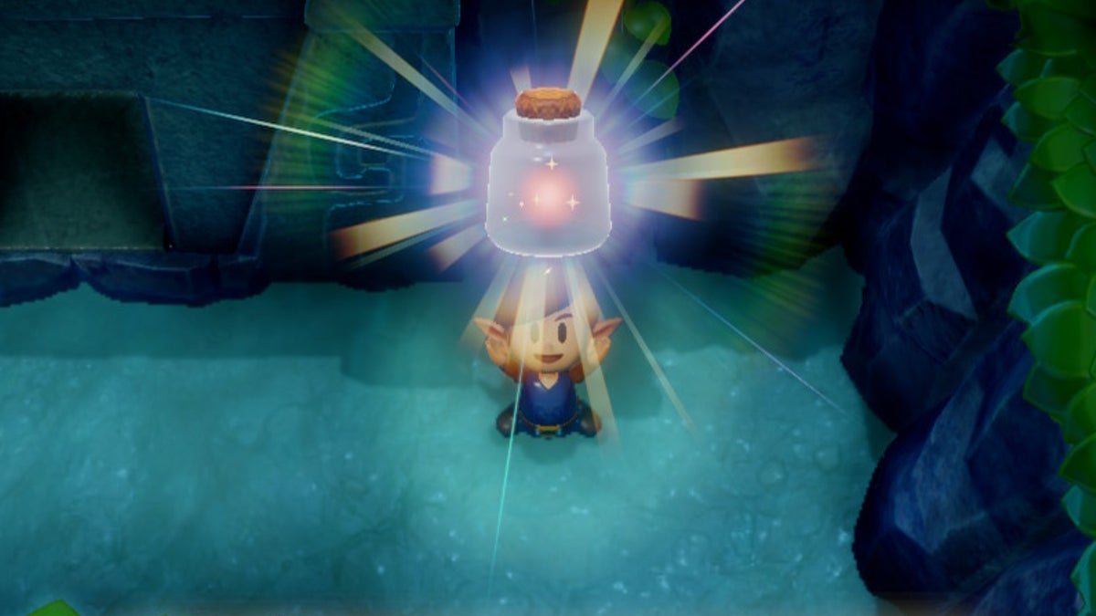 Link holding a full Fairy Bottle above their head. The glass bottle has a pink glowing sphere inside.