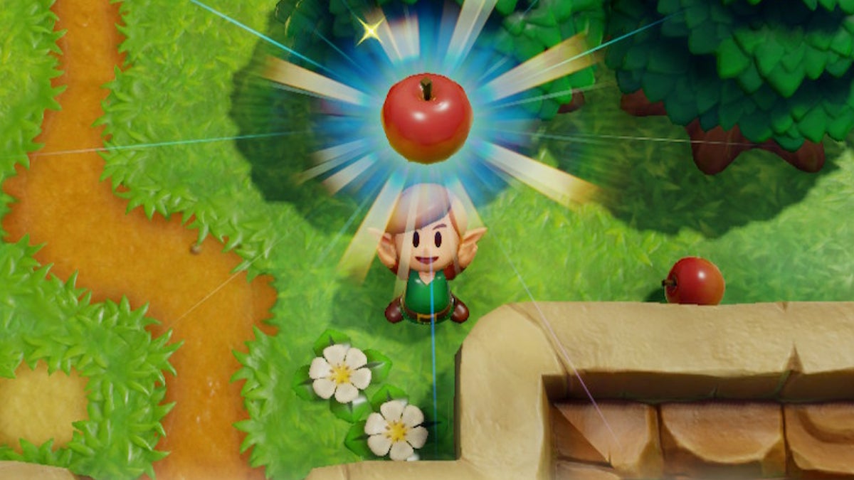Link holding a Red Apple above his head.