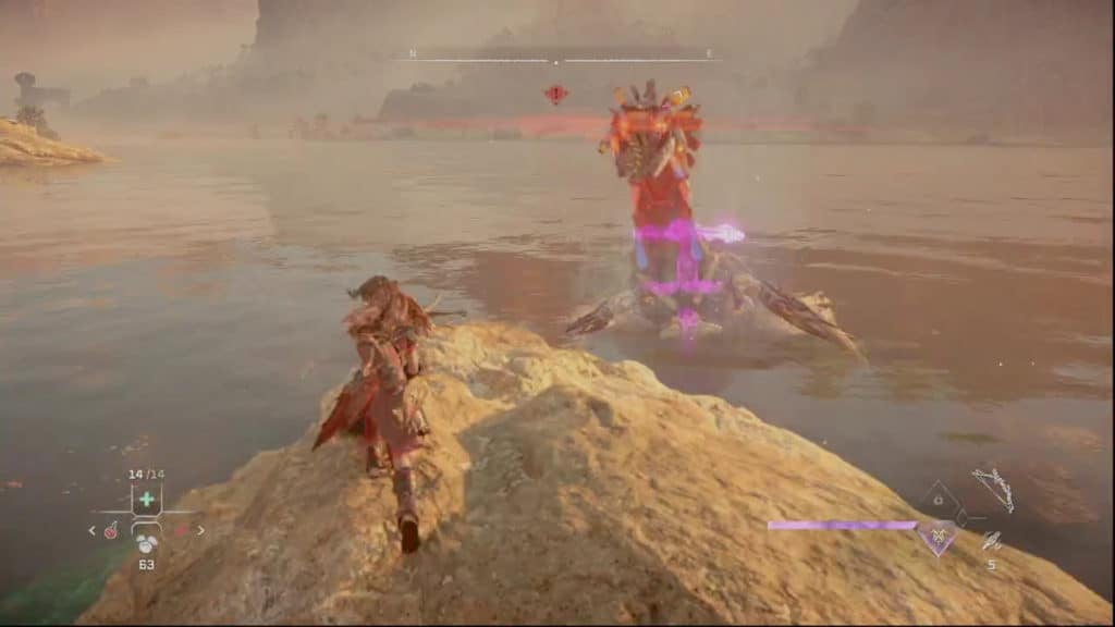 Aloy fighting a Tideripper while standing on a rock near the shore. The Tideripper is staring at Aloy aggressively.