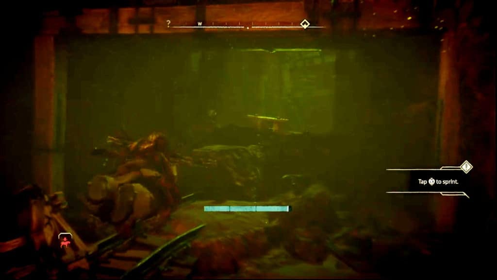 Aloy is swimming through murky green water while heading west through a flooded passage.