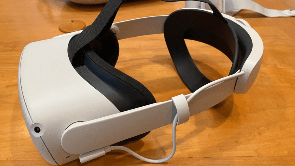 Oculus Quest 2 headset with strap, charging.