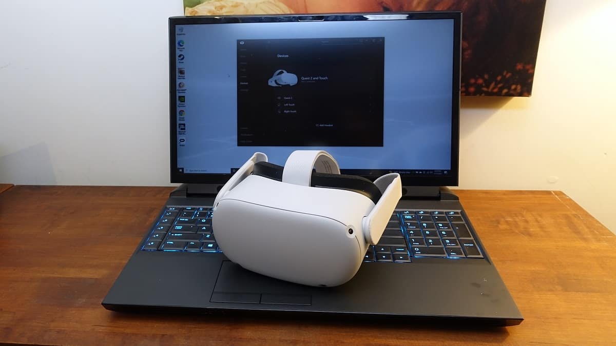 Oculus Quest 2 headset sitting on top of a laptop.