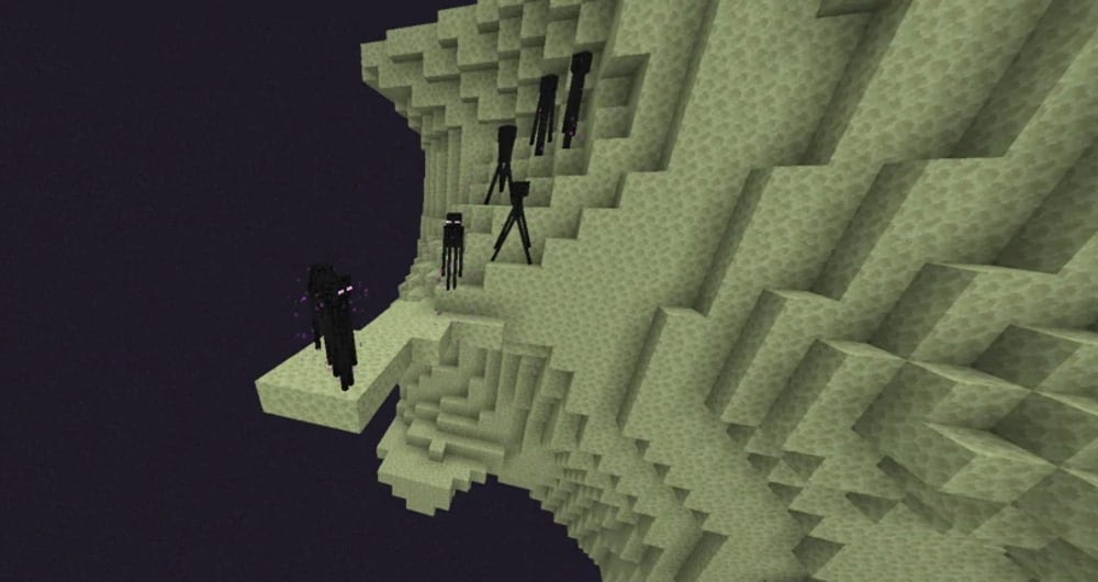 A cliff of end stone with many Endermen on the ledge.
