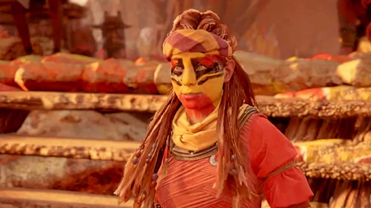 Medium shot of Aloy during a cutscene while she is wearing red, yellow, and black face paint.
