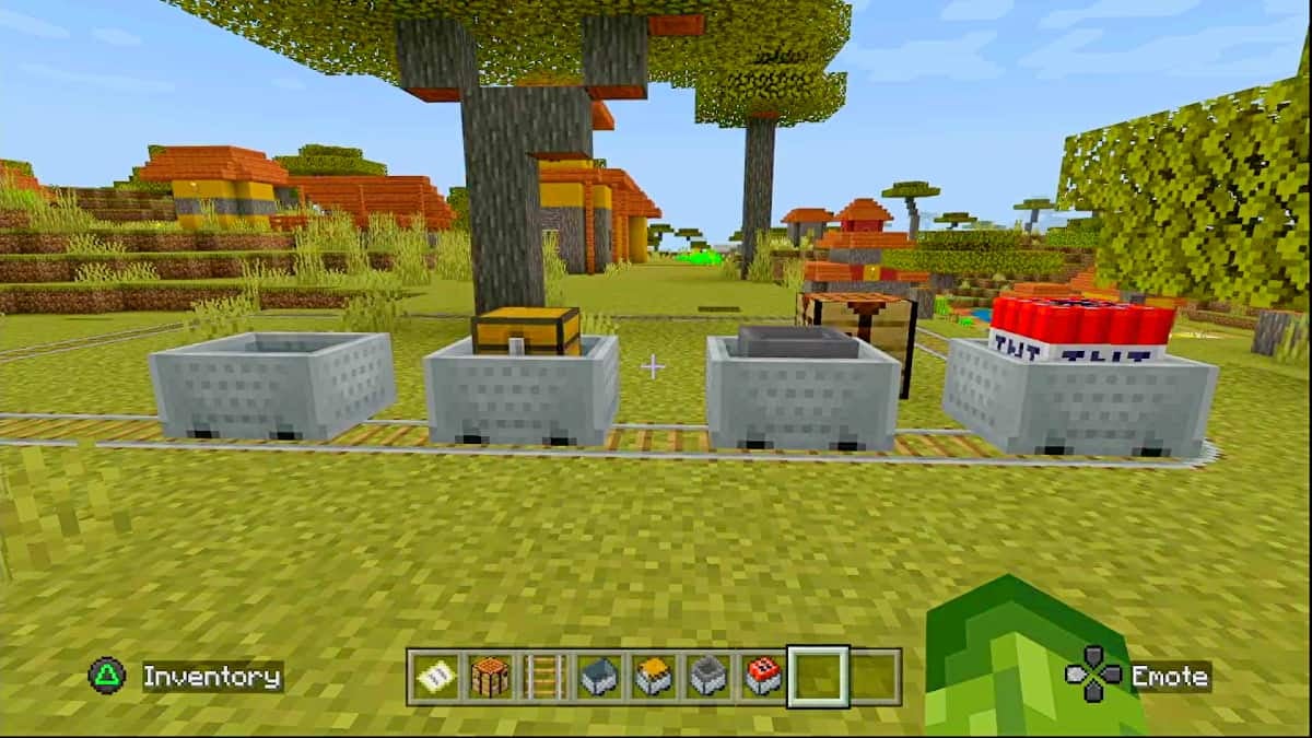 A simple rail circuit with a Minecart, a Minecart with Chest, a Minecart with Hopper, and a Minecart with TNT lined up in a field.