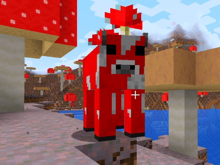 Closeup of a red mooshroom while it is looking at the player. In the background, many giant mushrooms can be seen.