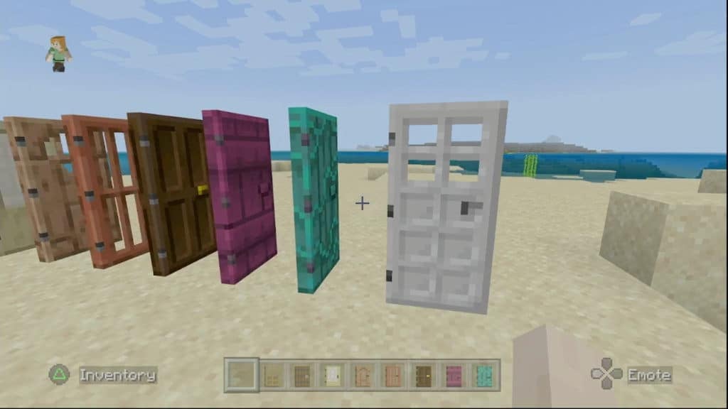 Many open wooden doors lined up on a beach next to a closed iron door.