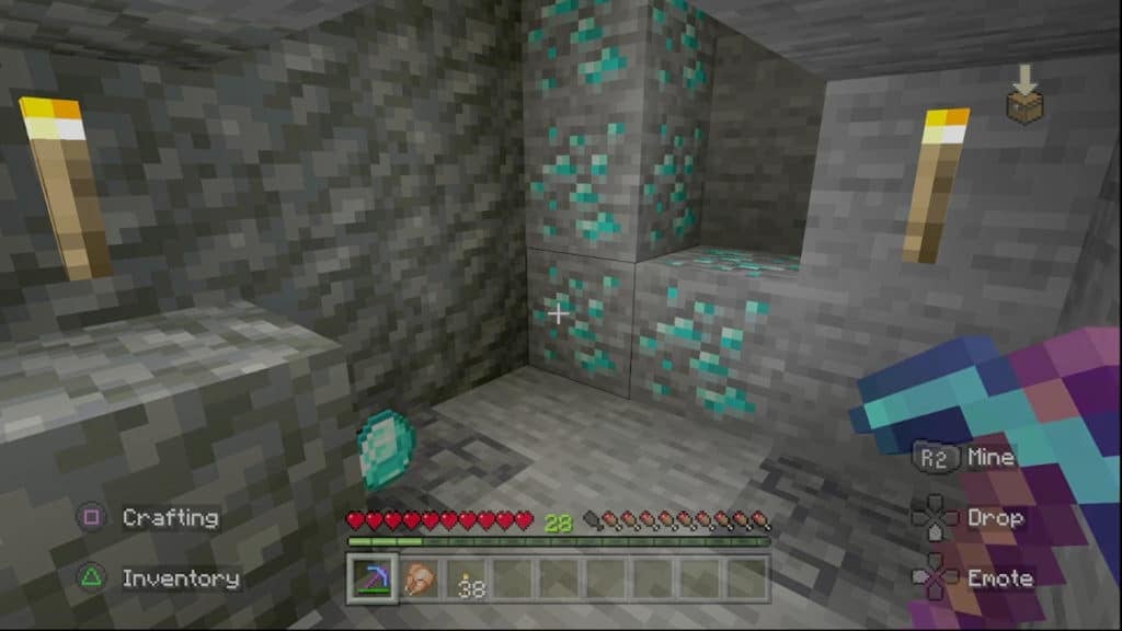 A player mining diamond ore blocks underground with a diamond pickaxe.