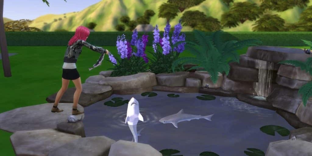 A Sim feeds fish in The Sims 4.