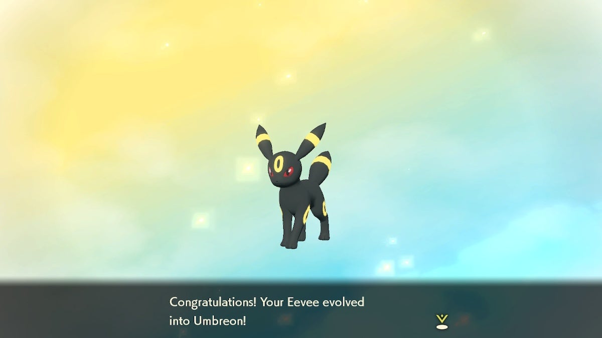 Umbreon is standing in front of a yellow and blue background with congratulatory text underneath them.