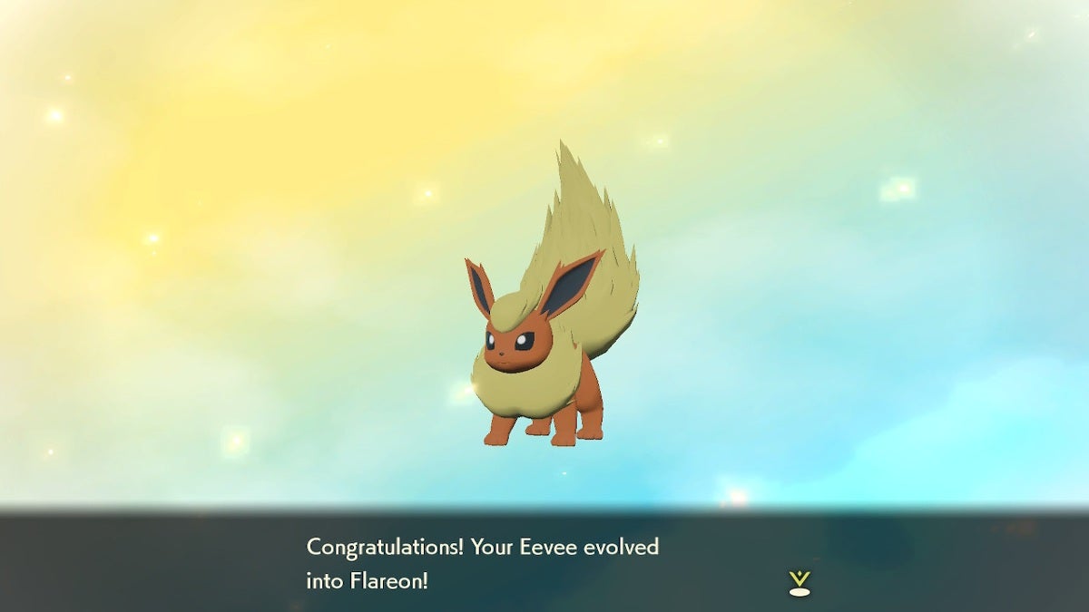 One of the Eevee evolutions. Flareon is standing in front of a yellow and blue background with congratulatory text underneath them.