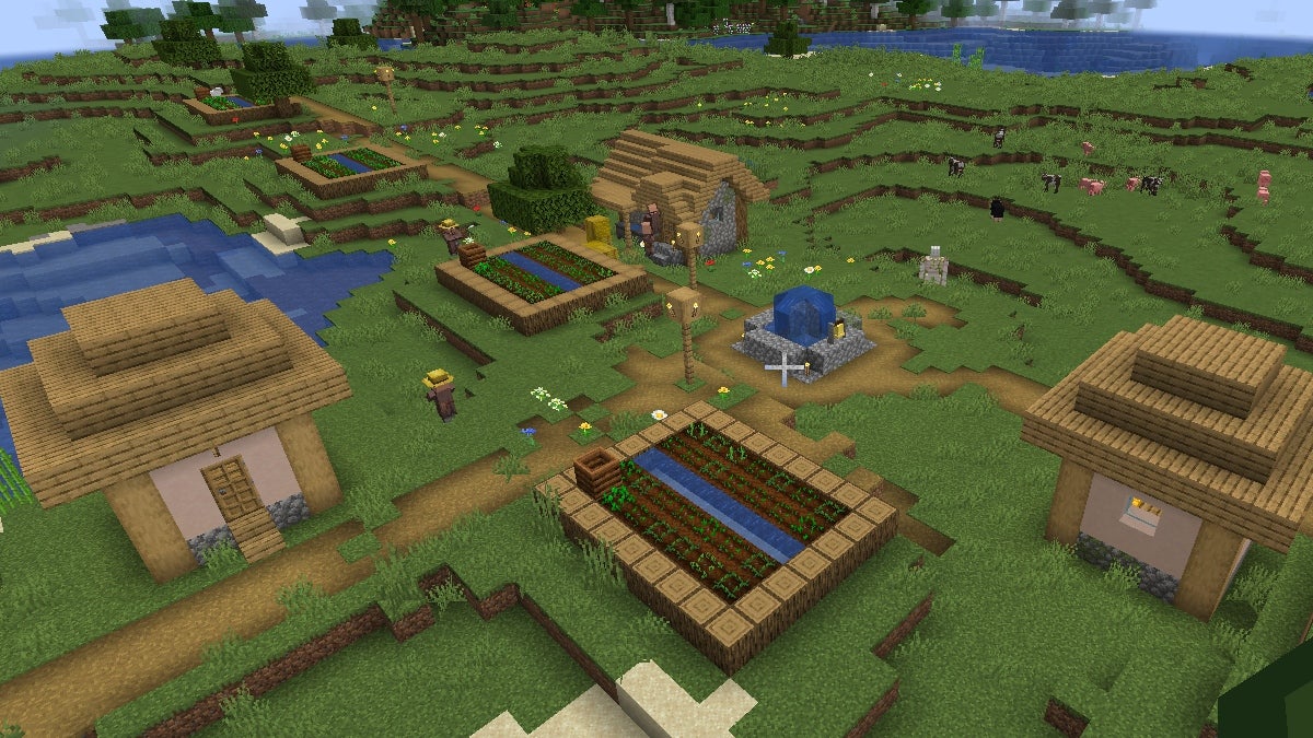 A zoomed-out view of a village in Minecraft—the biggest open world game.
