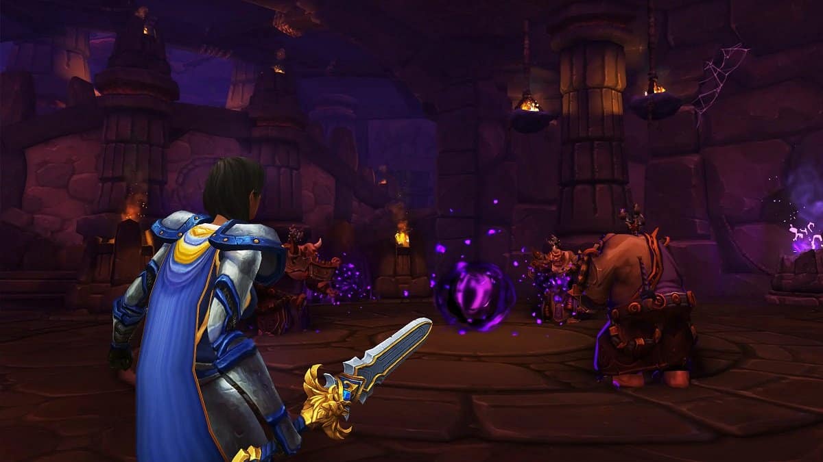Character with a sword fighting enemies in World of Warcraft.