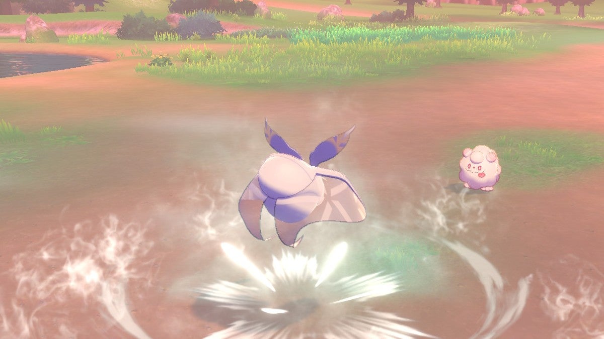 A Frosmoth using Defog on a Swirlix in a Generation VIII Pokémon Game.