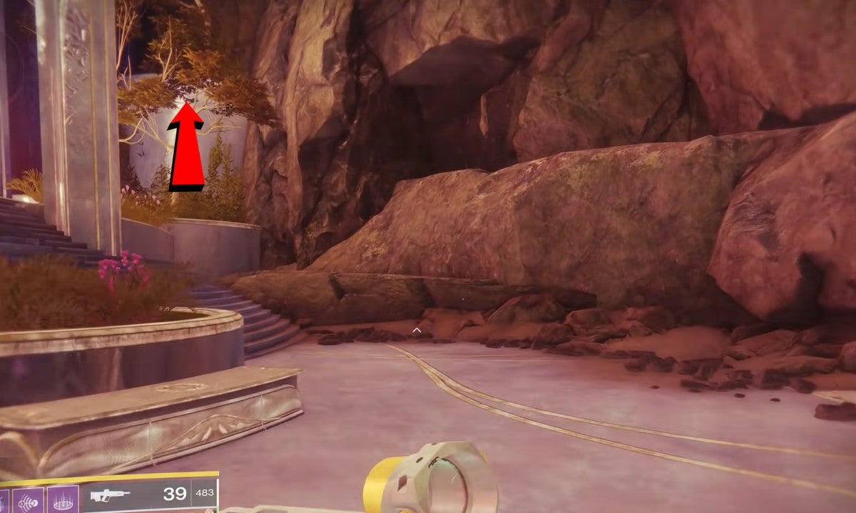 A red arrow showing the path up the ledge outside Harbinger's Seclude to reach the seventh cat statue.