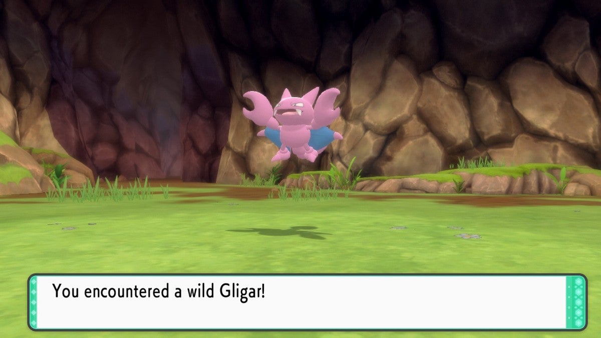 A wild Gligar appearing in a sunlit cavern.