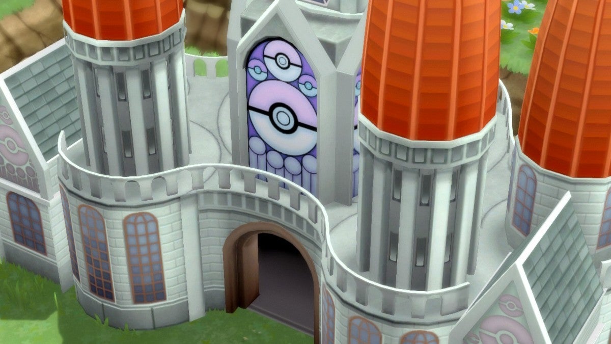 The exterior of the Pokémon League, which looks like a cathedral with a purple stain glass window featuring Poké Balls.