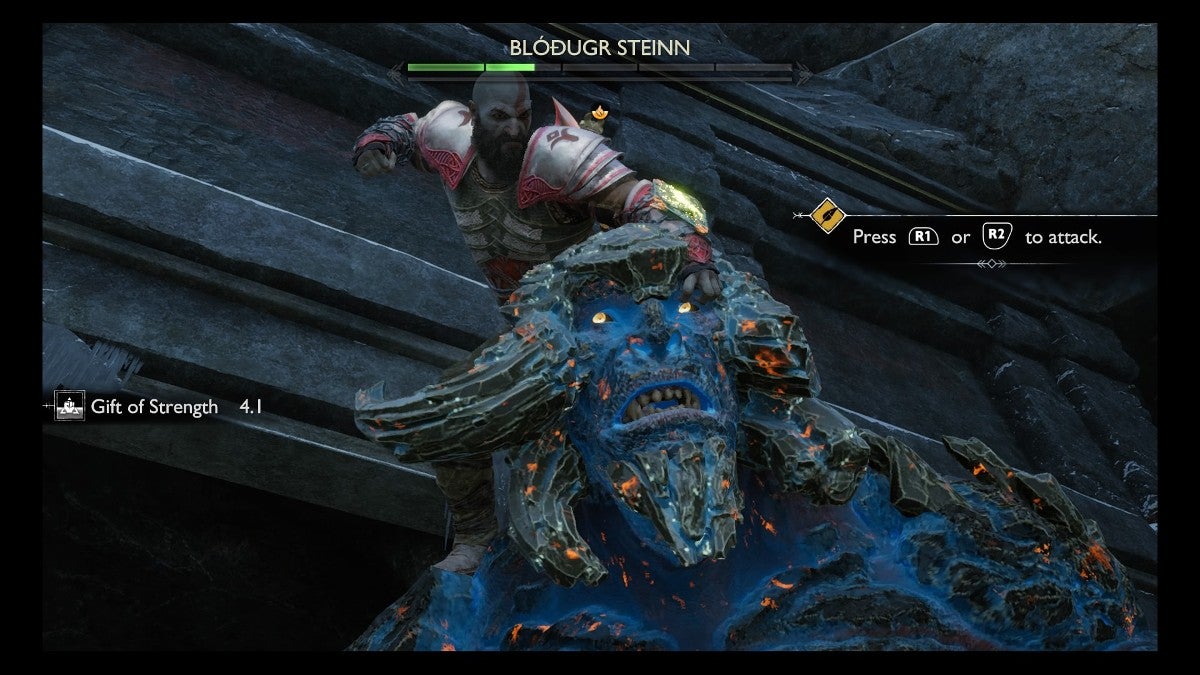 Kratos about to punch a Troll in the head.