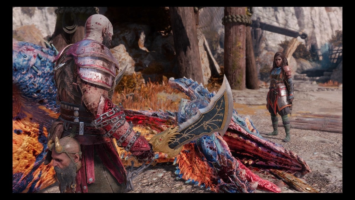Kratos and Freya looking at a dead dragon.