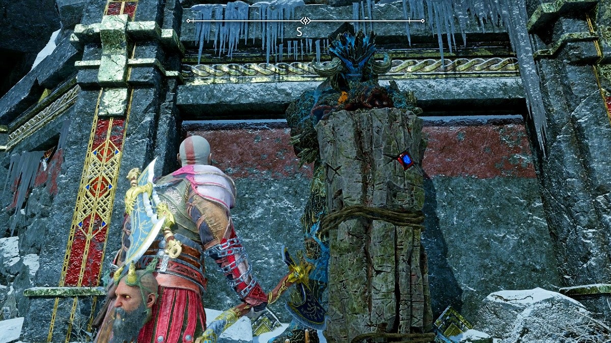Kratos looking at a troll statue.