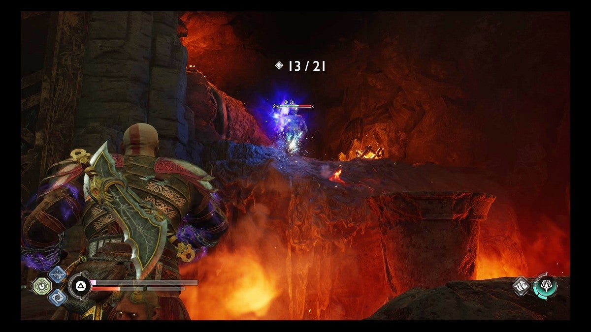Kratos hitting a ledge enemy in the legs with the Leviathan Axe.
