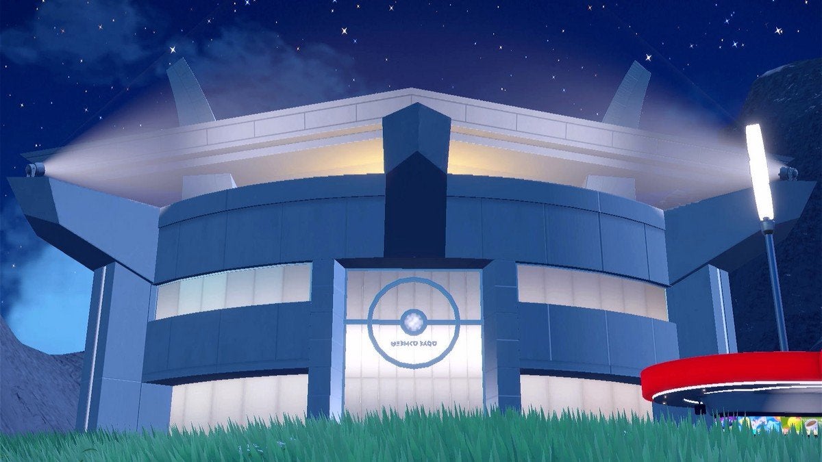 The front of the Pokémon League building at night.