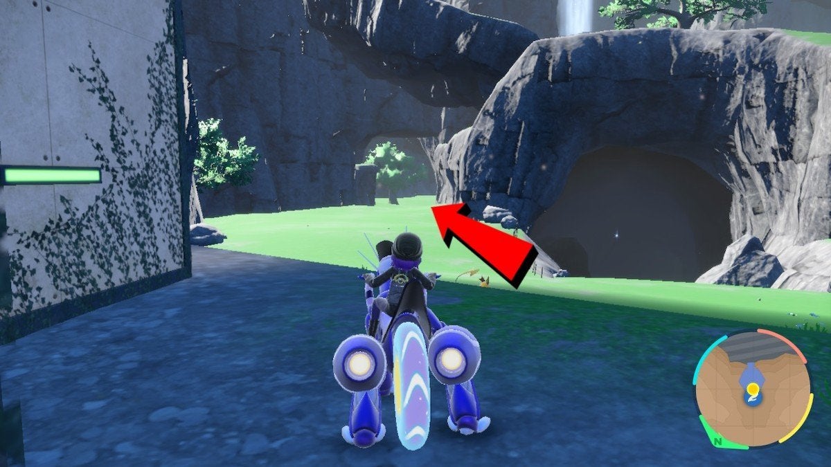 A red arrow pointing player towards a grassy path on the left.