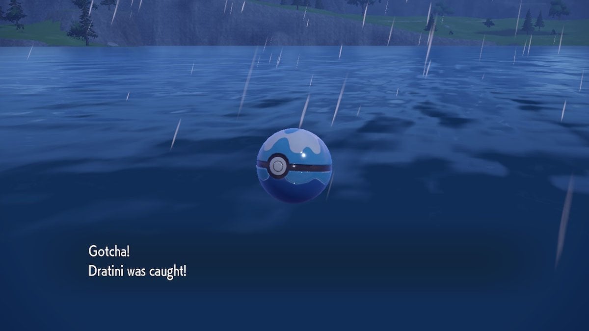 A player catching a Dratini in a blue Dive Ball.