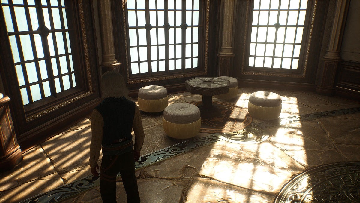 Footstools around a small table in Hogwarts Legacy.