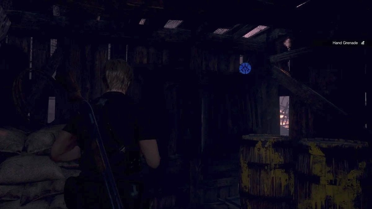 Leon facing the blue medallion inside the shack in the Fish Farm.