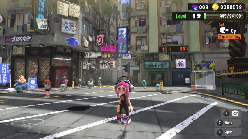 A character standing in the main Splatsville square in Splatoon 3 with the Hotlantis general store behind them