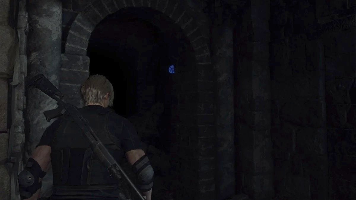 Leon looking at a blue medallion in the Cliffside Ruins.